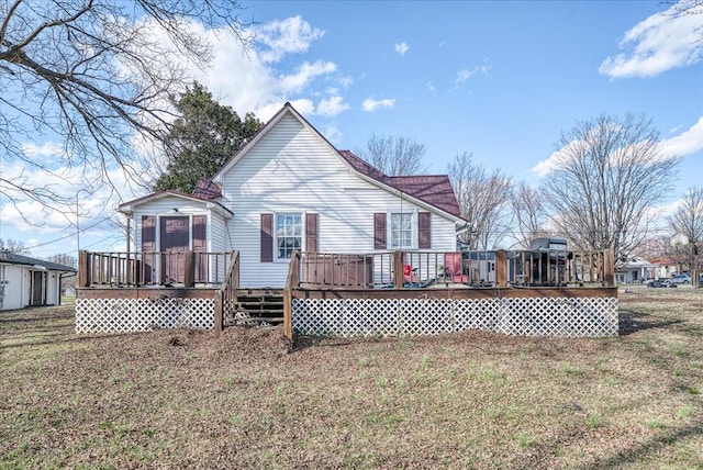 rear view of house with a lawn and a wooden deck