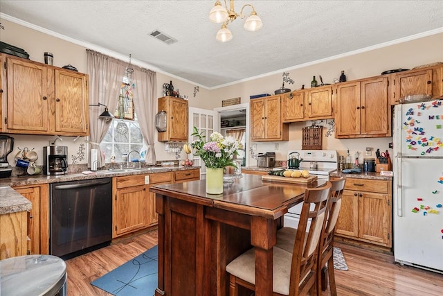 kitchen with light wood-style floors, freestanding refrigerator, dishwasher, and a sink