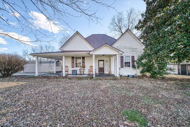 view of front of house featuring metal roof and a porch