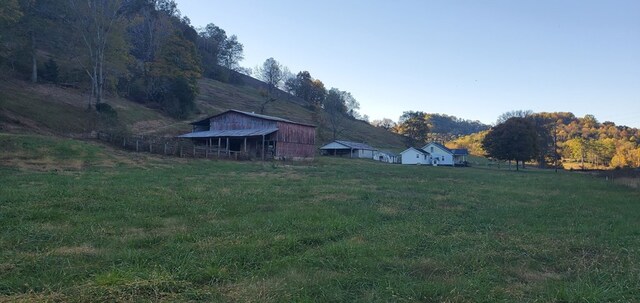 view of yard featuring a rural view and a barn