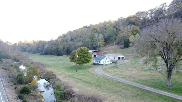 drone / aerial view with a wooded view