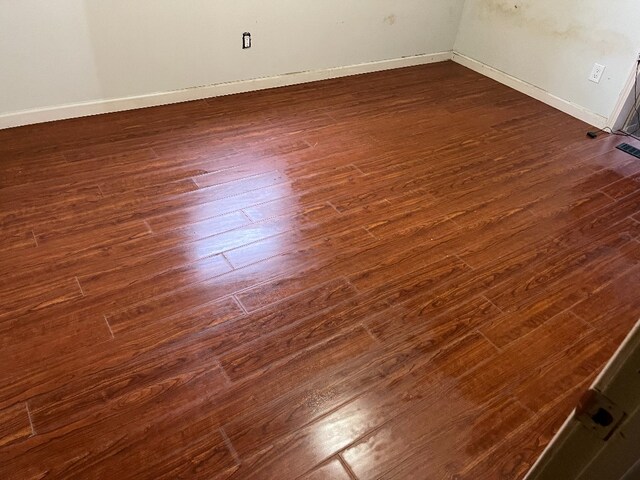 interior space featuring baseboards and wood finished floors