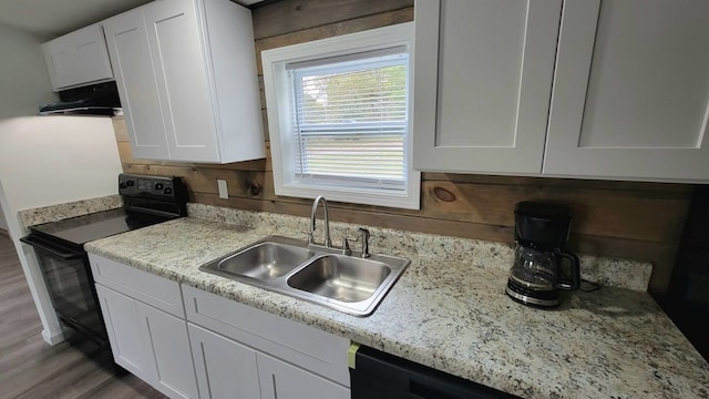 kitchen featuring a sink, under cabinet range hood, white cabinets, and black electric range oven