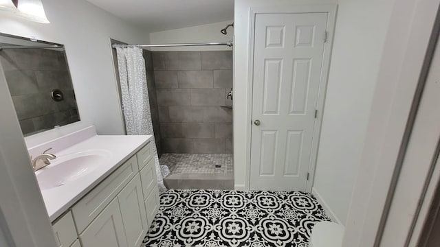 full bath featuring a shower stall, vanity, and tile patterned floors