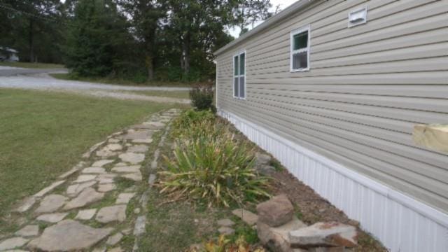 view of property exterior with a lawn