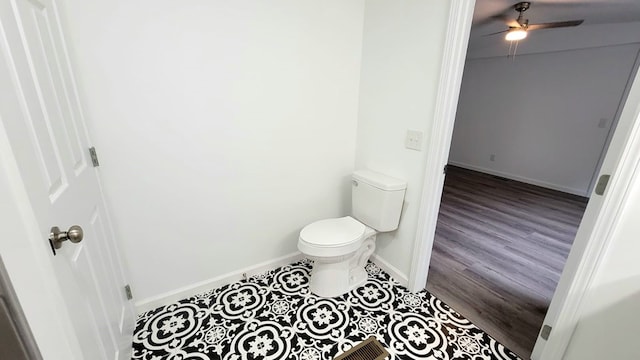 bathroom featuring a ceiling fan, baseboards, toilet, and wood finished floors