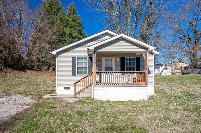 bungalow-style home with a front yard, crawl space, and covered porch