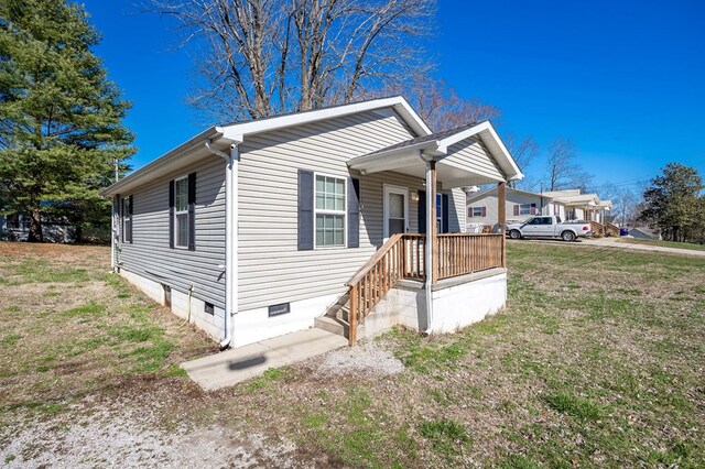 view of home's exterior featuring crawl space and a lawn