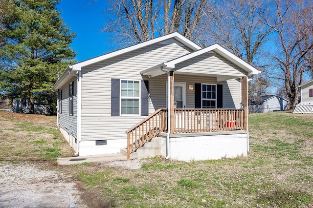 bungalow-style house with covered porch, crawl space, and a front yard