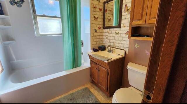 bathroom with vanity, shower / bathtub combination with curtain, toilet, and tile patterned floors