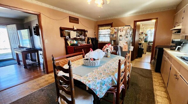 dining area featuring ornamental molding and dark floors