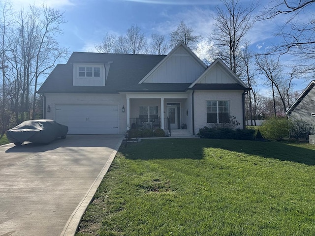 view of front of house featuring covered porch, a front yard, driveway, and an attached garage