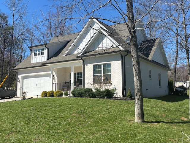 view of front facade featuring brick siding, driveway, a front lawn, and an attached garage
