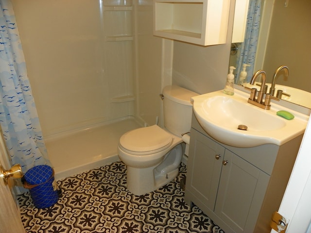 bathroom featuring toilet, a shower stall, tile patterned flooring, and vanity