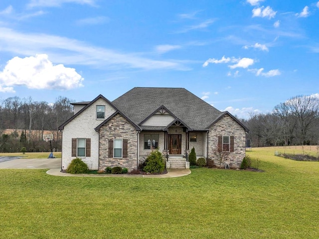 view of front of house with roof with shingles and a front yard