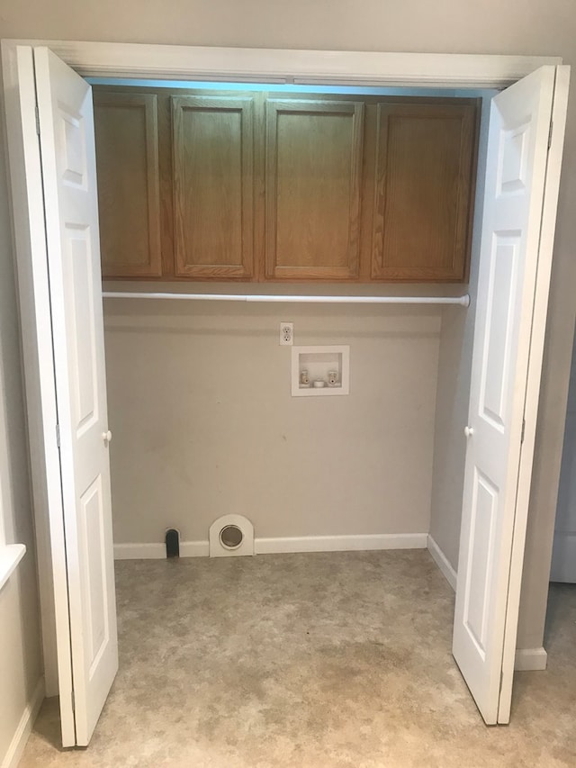 clothes washing area with hookup for a washing machine and baseboards