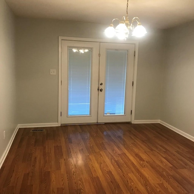 doorway to outside with baseboards, visible vents, dark wood-style floors, an inviting chandelier, and french doors