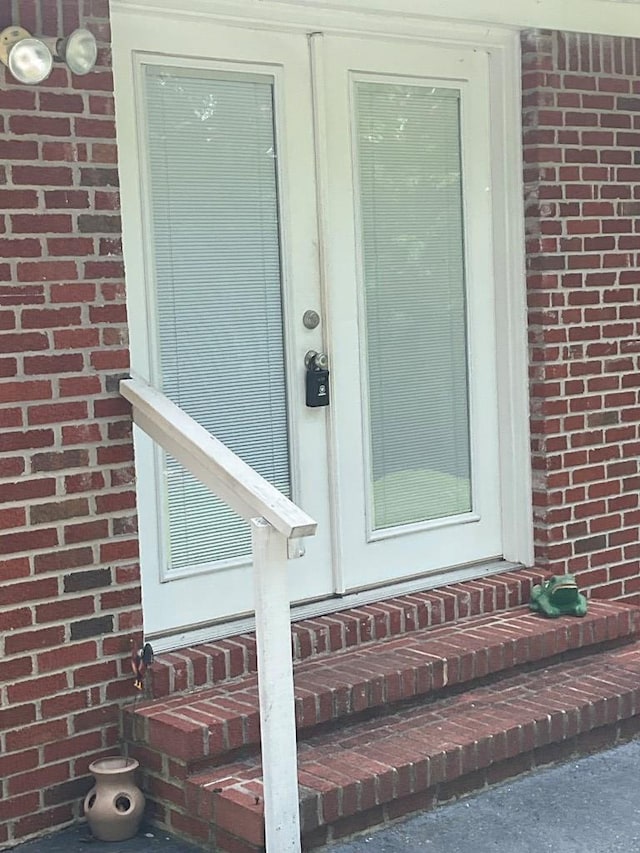 property entrance featuring brick siding