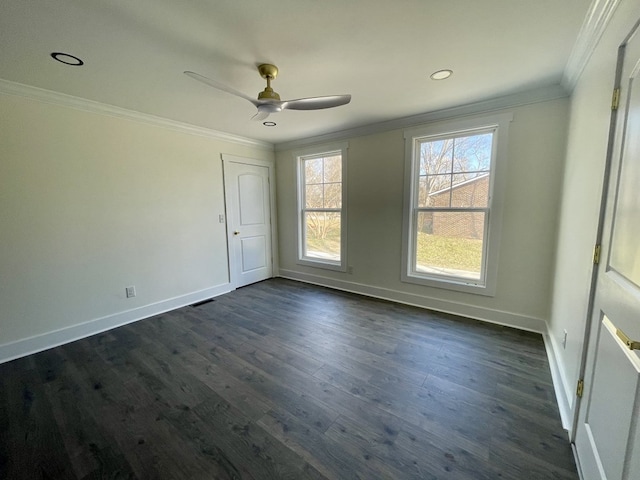 unfurnished room with dark wood-style floors, ceiling fan, baseboards, and crown molding