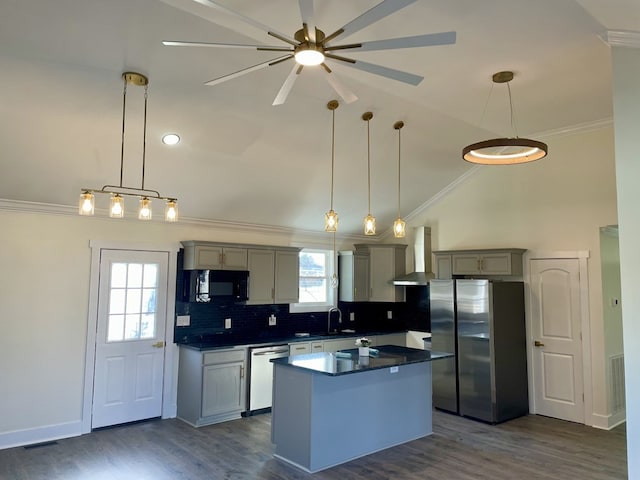 kitchen featuring gray cabinetry, stainless steel appliances, wall chimney exhaust hood, dark countertops, and pendant lighting