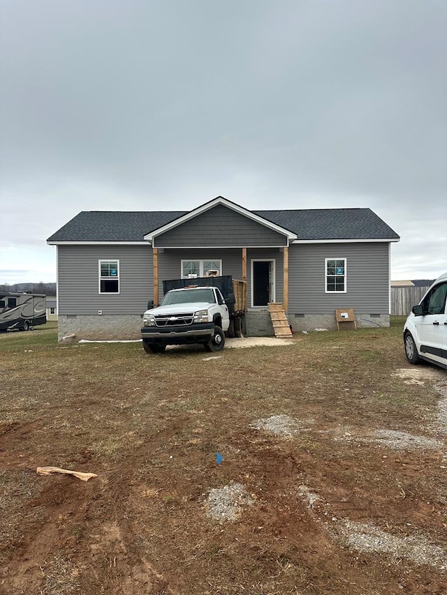 view of front of house featuring a shingled roof, entry steps, and crawl space