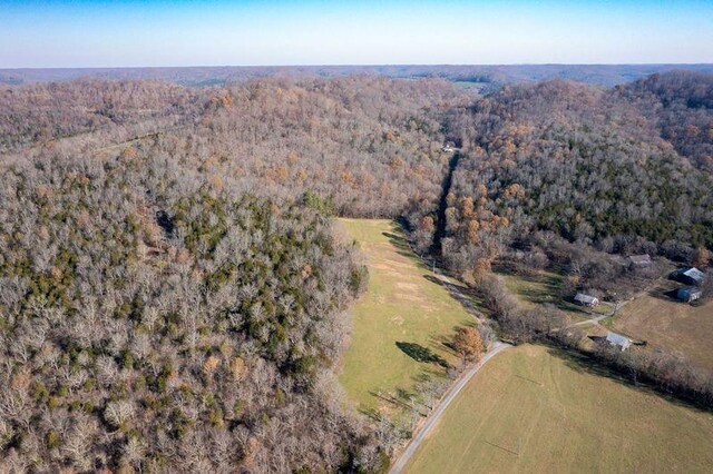 drone / aerial view featuring a view of trees