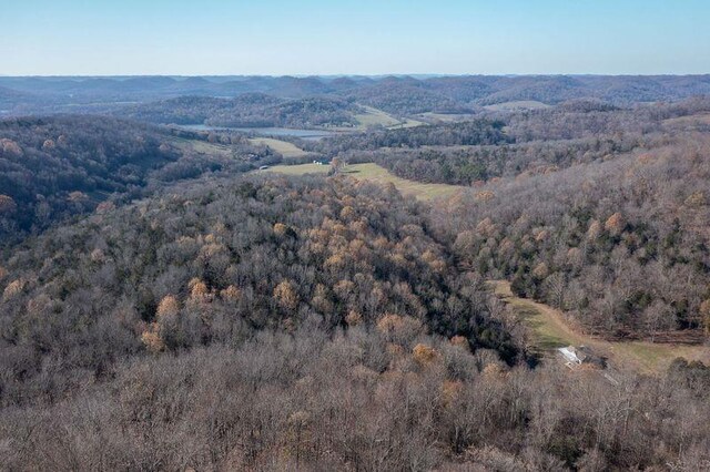 birds eye view of property featuring a view of trees