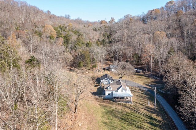 birds eye view of property with a forest view