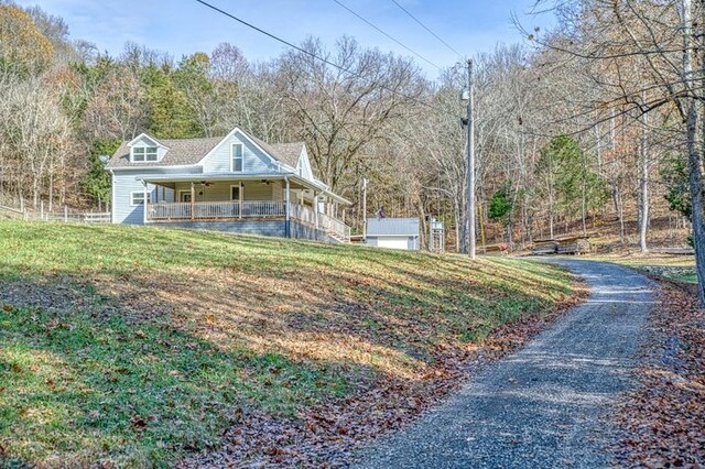 view of front of property with a porch and a front yard