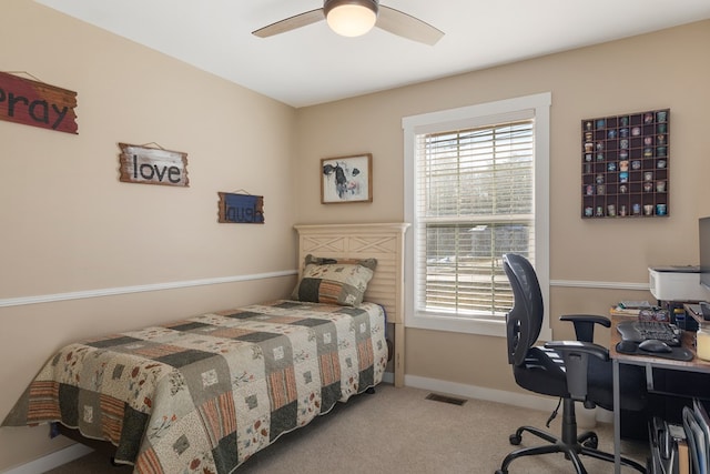 bedroom with ceiling fan, multiple windows, baseboards, and light colored carpet