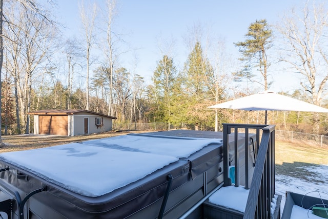 view of yard featuring an outbuilding, fence, and a hot tub