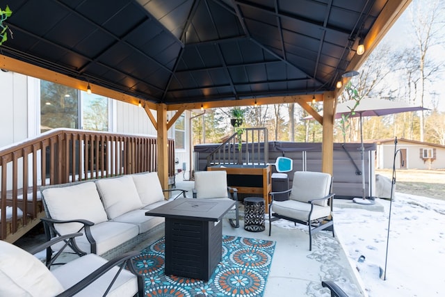 view of patio with a hot tub, a gazebo, and an outdoor hangout area