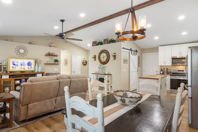 dining space featuring recessed lighting, lofted ceiling with beams, a barn door, light wood-style floors, and ceiling fan with notable chandelier