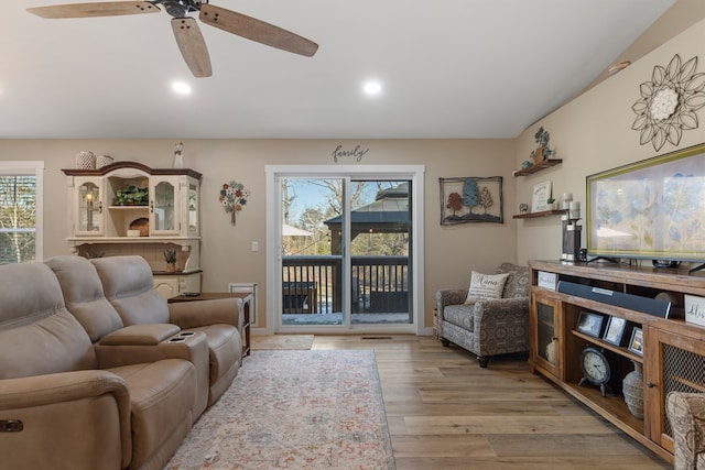 living area featuring light wood finished floors, plenty of natural light, and recessed lighting