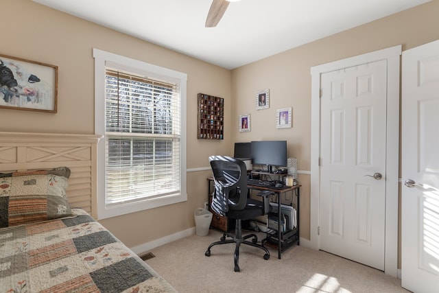 bedroom featuring light carpet, multiple windows, and baseboards