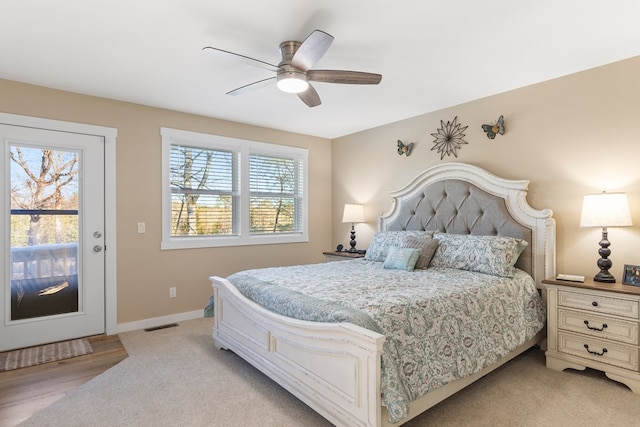 bedroom featuring a ceiling fan, access to exterior, visible vents, and baseboards