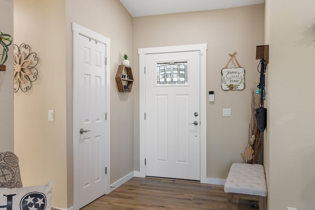 entrance foyer featuring wood finished floors and baseboards