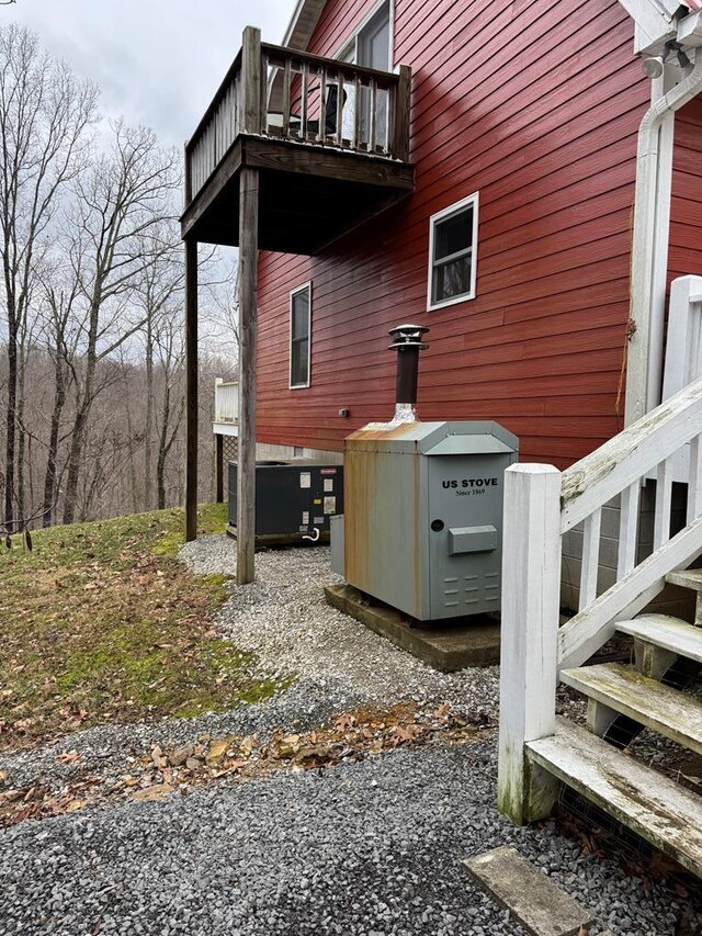 view of home's exterior featuring cooling unit and a balcony