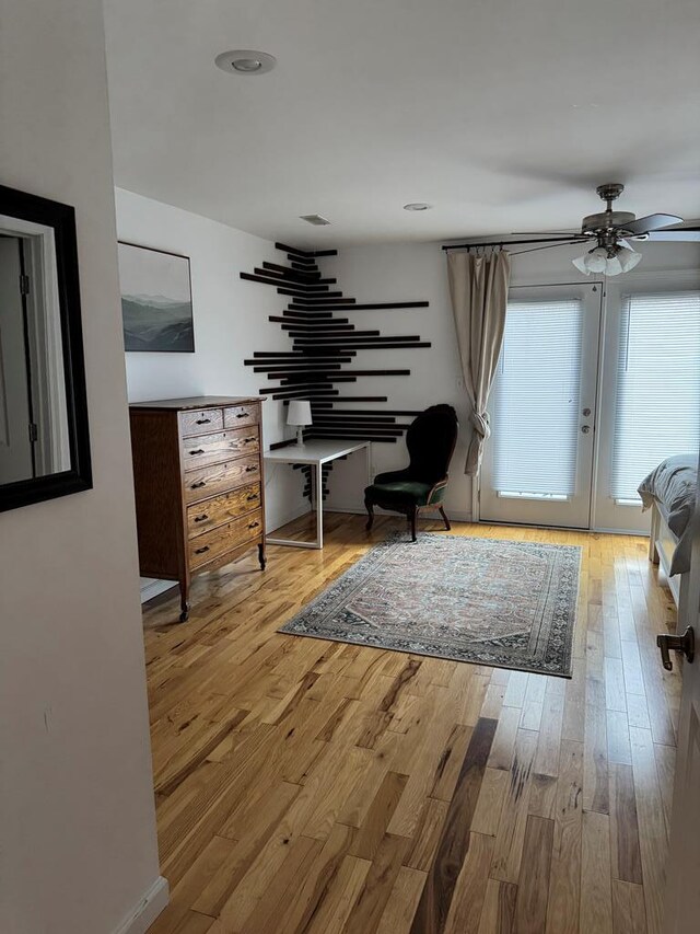 living area featuring ceiling fan and wood finished floors