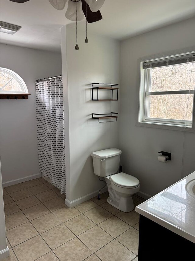 bathroom featuring tile patterned flooring, a wealth of natural light, and vanity