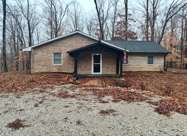 single story home featuring brick siding