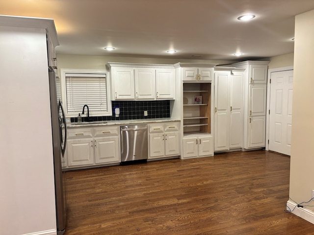 kitchen featuring dark wood-style floors, stainless steel appliances, a sink, and white cabinets