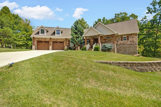 view of front of house with driveway, an attached garage, a front yard, a porch, and brick siding