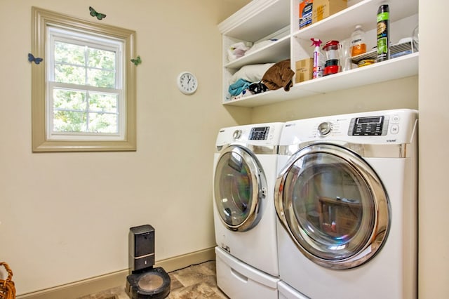 laundry room with laundry area, separate washer and dryer, and baseboards