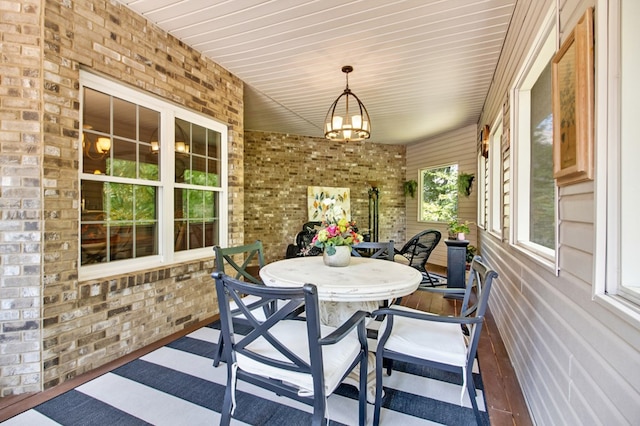 sunroom / solarium with an inviting chandelier