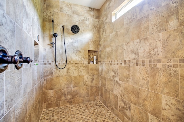 full bath with a tile shower