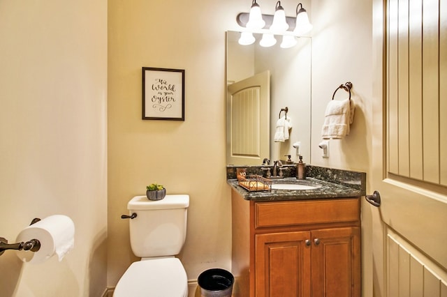 bathroom featuring toilet and vanity