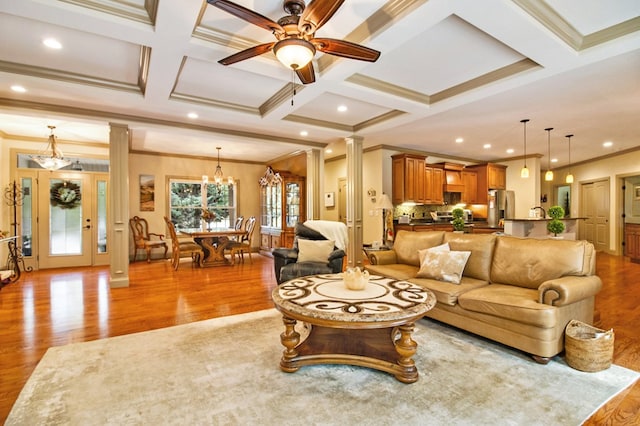 living room featuring coffered ceiling, decorative columns, and light wood finished floors