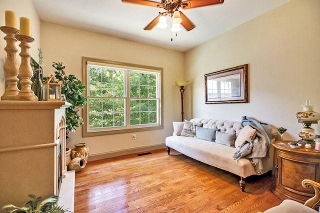 interior space with light wood-style floors, ceiling fan, visible vents, and baseboards