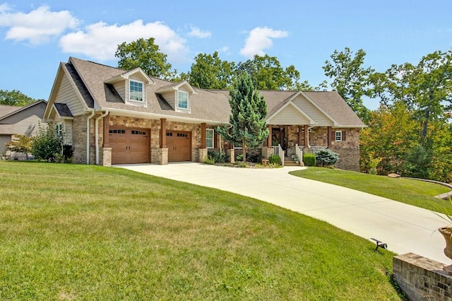 view of front of house with a porch, a front yard, stone siding, and driveway